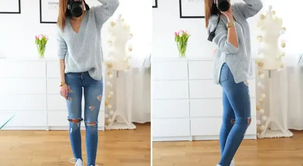 Szary sweter, podarte jeansy i białe sneakersy – oto idealny outfit na co dzień.