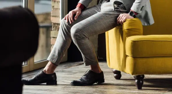 Eleganckie, ciemne buty męskie do szarego garnituru w kratę. Stylowa inspiracja.