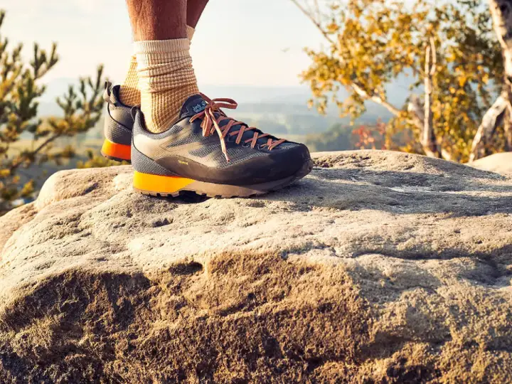 Idealne buty w Bieszczady? Te trekkingowe z pomarańczowymi akcentami zapewnią komfort na skalistym szlaku.